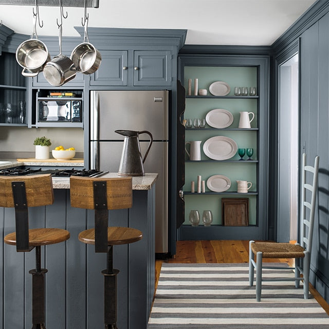 Kitchen with blue-grey painted cabinets and island, illustrating premium kitchen cabinet paints