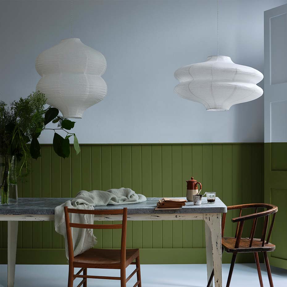 Bright dining room with green panelling and natural light